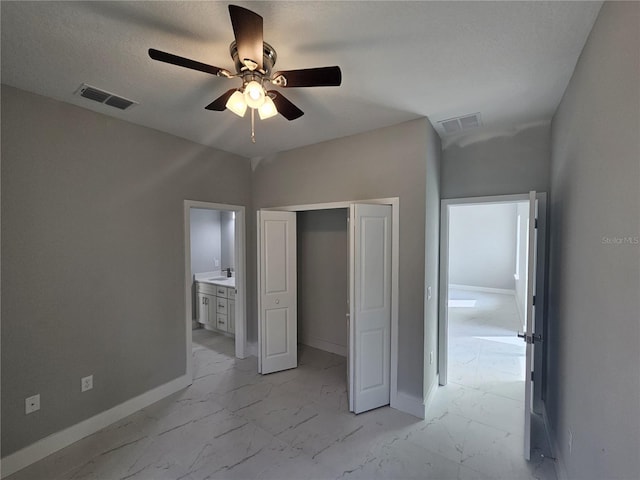 unfurnished bedroom featuring marble finish floor, a closet, visible vents, and baseboards