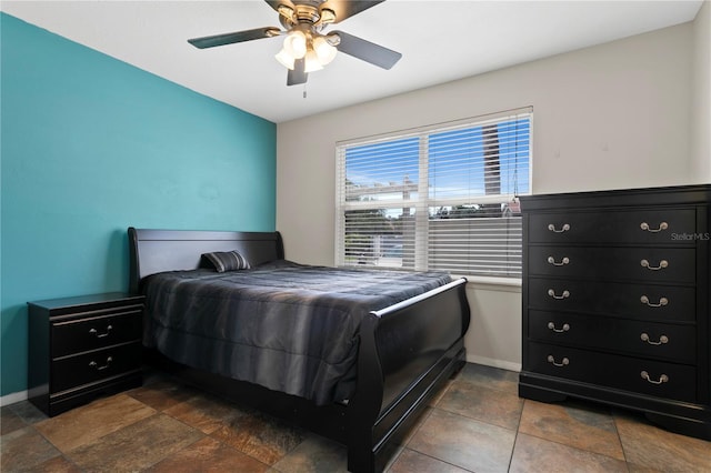 bedroom featuring a ceiling fan and baseboards