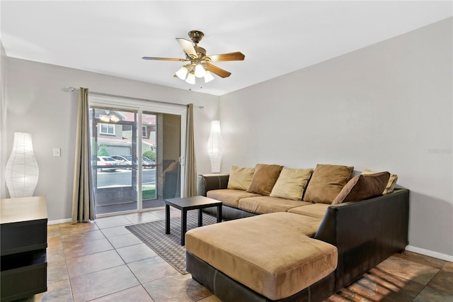 tiled living area featuring ceiling fan and baseboards