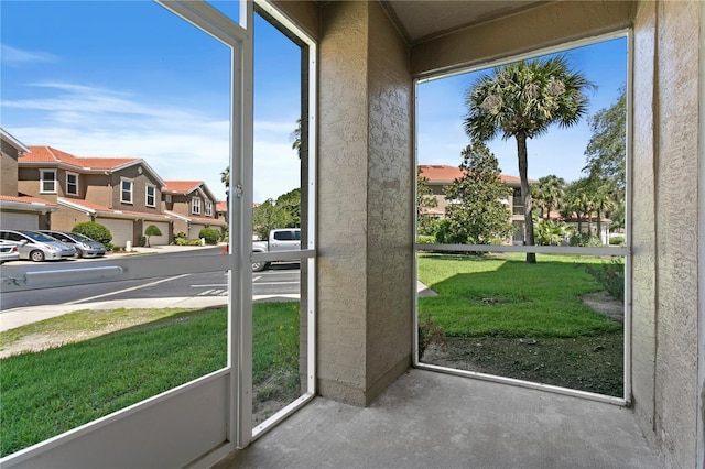 doorway featuring concrete flooring and a residential view