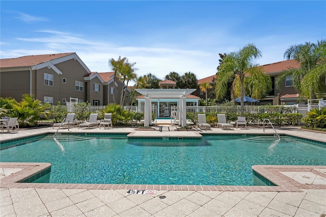 pool featuring fence, a pergola, and a patio