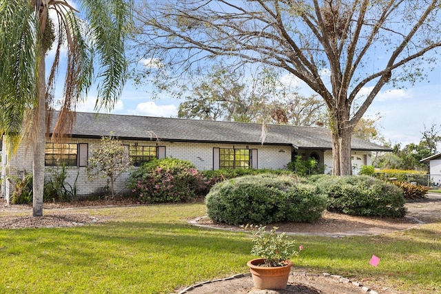 ranch-style home with a front lawn and brick siding