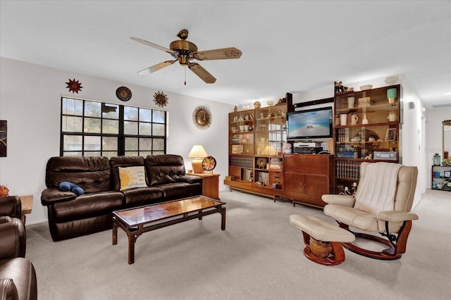 carpeted living area featuring ceiling fan