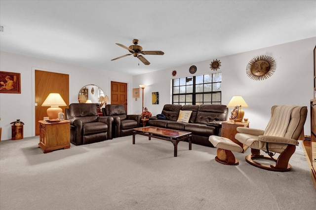 carpeted living room with ceiling fan