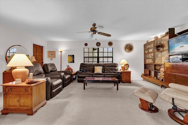 living room with a ceiling fan and light carpet