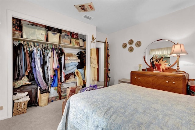 carpeted bedroom featuring a closet and visible vents