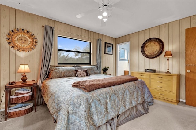 bedroom with a ceiling fan and light colored carpet