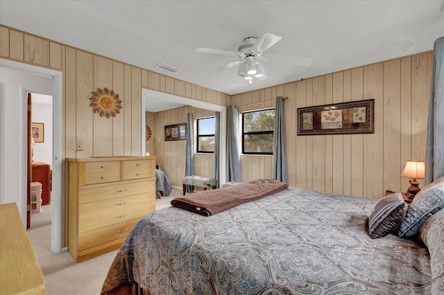 bedroom with light carpet, ceiling fan, and visible vents