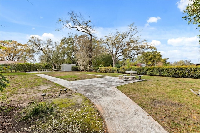 surrounding community featuring an outbuilding and a lawn