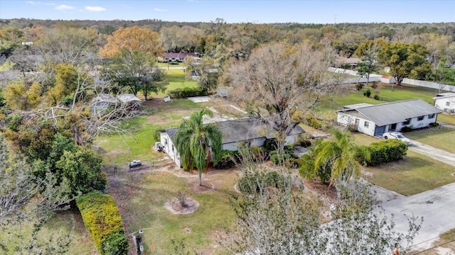 birds eye view of property featuring a view of trees