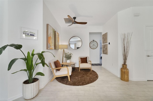 sitting room featuring wood finished floors, a ceiling fan, and baseboards