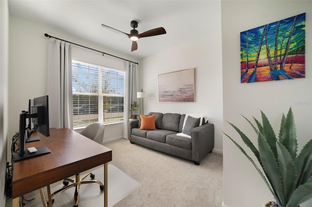 carpeted office with a ceiling fan and baseboards