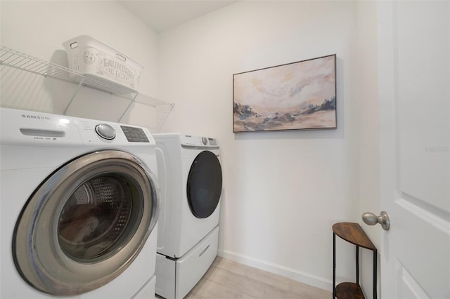 laundry room with washing machine and dryer, laundry area, and baseboards