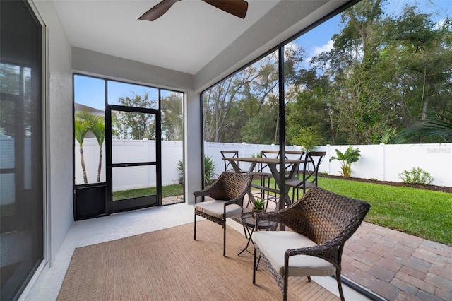 sunroom / solarium featuring ceiling fan