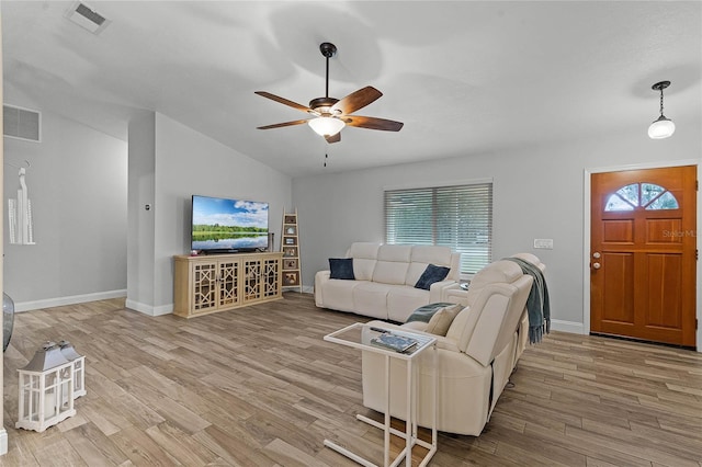 living area with a healthy amount of sunlight, visible vents, and wood finished floors