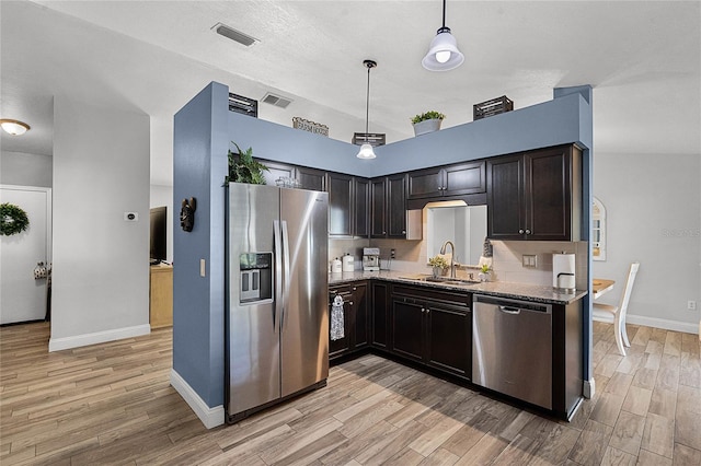 kitchen with light wood-style floors, visible vents, appliances with stainless steel finishes, and a sink