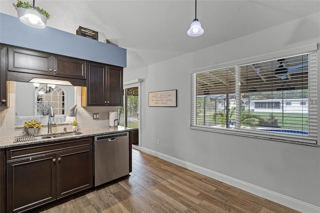 kitchen with tasteful backsplash, dishwasher, wood finished floors, dark brown cabinets, and a sink