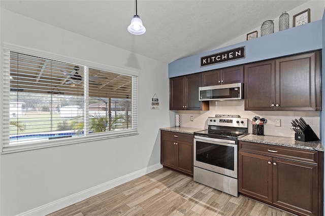 kitchen with light wood finished floors, decorative backsplash, lofted ceiling, appliances with stainless steel finishes, and dark brown cabinets