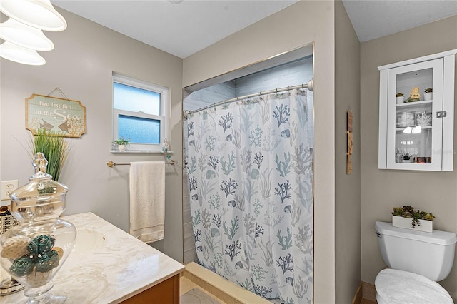 full bath with curtained shower, vanity, and toilet