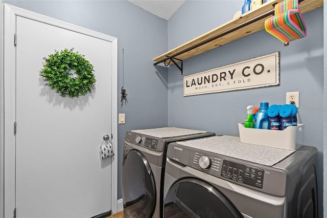 washroom featuring laundry area and washer and clothes dryer