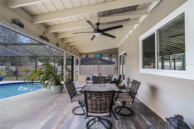 view of patio featuring ceiling fan, a fenced backyard, a lanai, a fenced in pool, and outdoor dining space