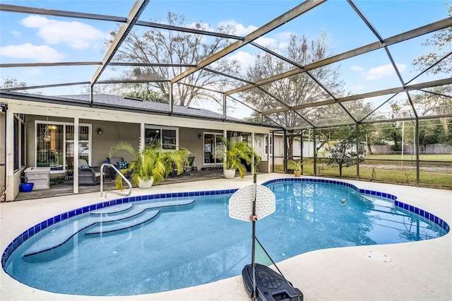 pool with glass enclosure and a patio area