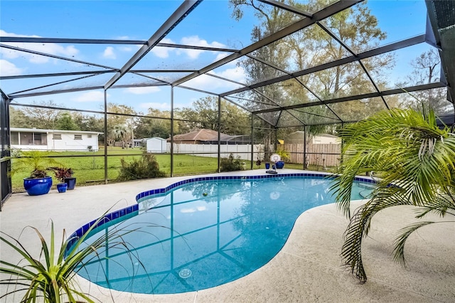 view of swimming pool featuring a fenced in pool, a patio, a lawn, fence, and a lanai