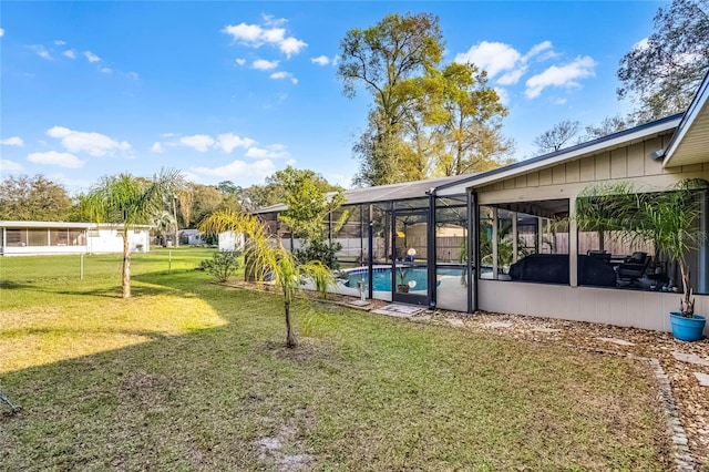 view of yard with glass enclosure and a fenced in pool