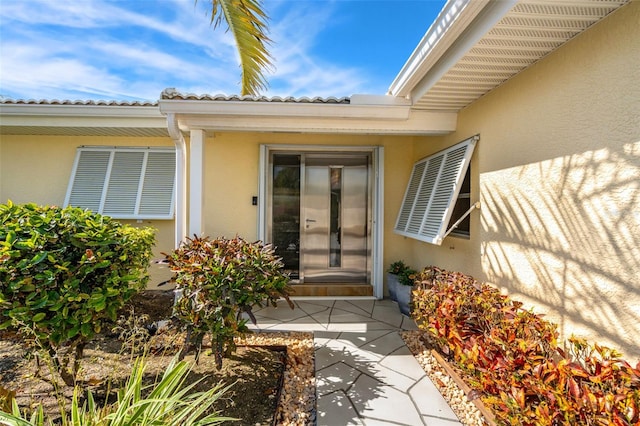 doorway to property with stucco siding