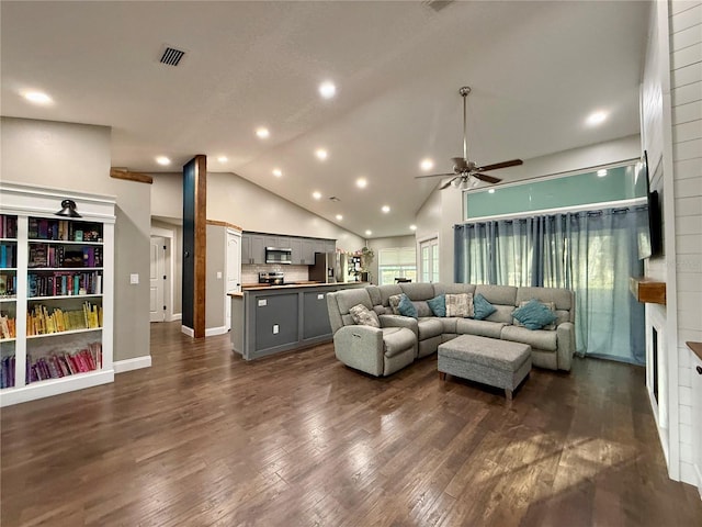 living room featuring visible vents, dark wood-style floors, ceiling fan, a fireplace, and high vaulted ceiling