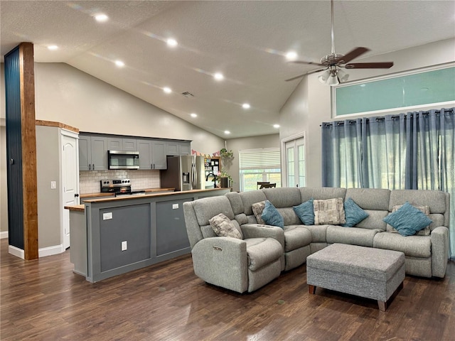 living room with dark wood-type flooring, visible vents, high vaulted ceiling, and a textured ceiling