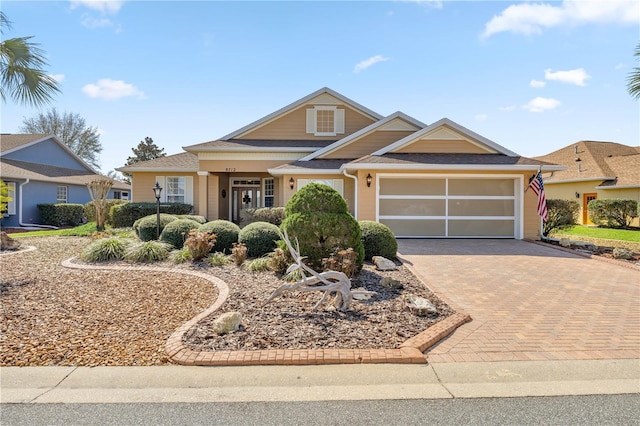 view of front facade with decorative driveway and an attached garage