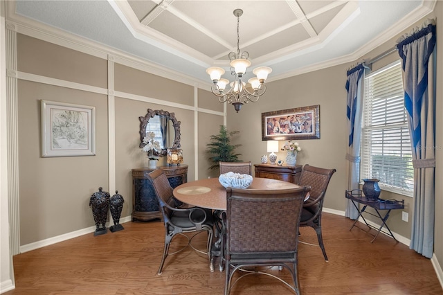 dining space featuring crown molding, wood finished floors, a raised ceiling, and an inviting chandelier