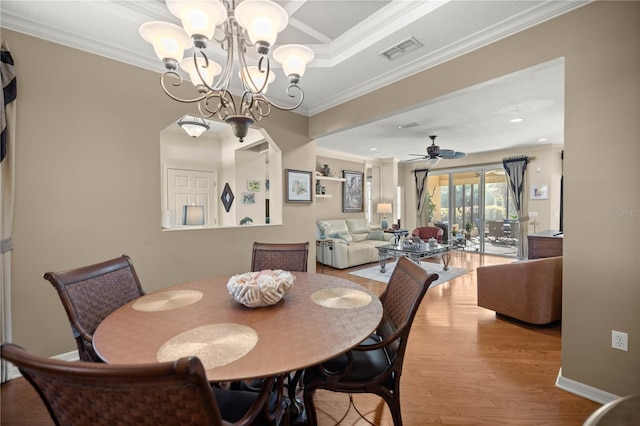 dining area with baseboards, visible vents, crown molding, and wood finished floors