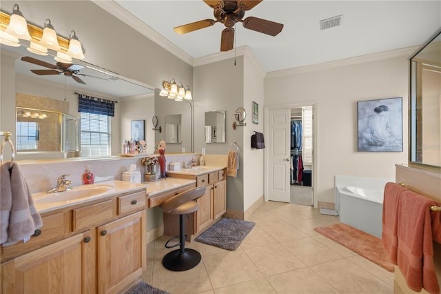 bathroom featuring visible vents, tile patterned floors, crown molding, a shower stall, and a sink