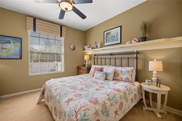 carpeted bedroom featuring ceiling fan and baseboards