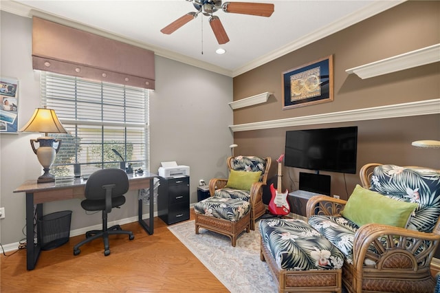 office area featuring ornamental molding, ceiling fan, baseboards, and wood finished floors