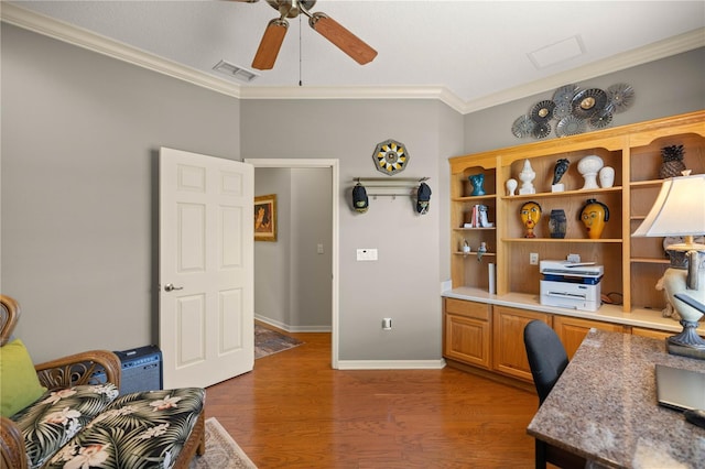 office space featuring visible vents, baseboards, a ceiling fan, wood finished floors, and crown molding