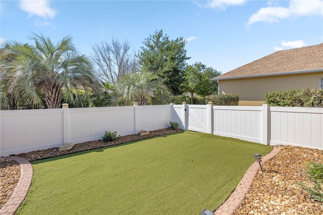 view of yard featuring a gate and a fenced backyard