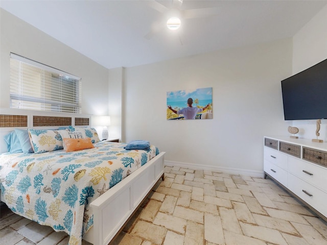 bedroom with baseboards and a ceiling fan