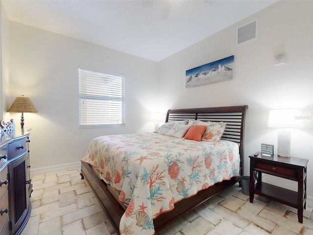 bedroom with visible vents, baseboards, and stone tile flooring