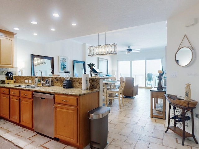 kitchen featuring light stone counters, recessed lighting, a peninsula, a sink, and stainless steel dishwasher