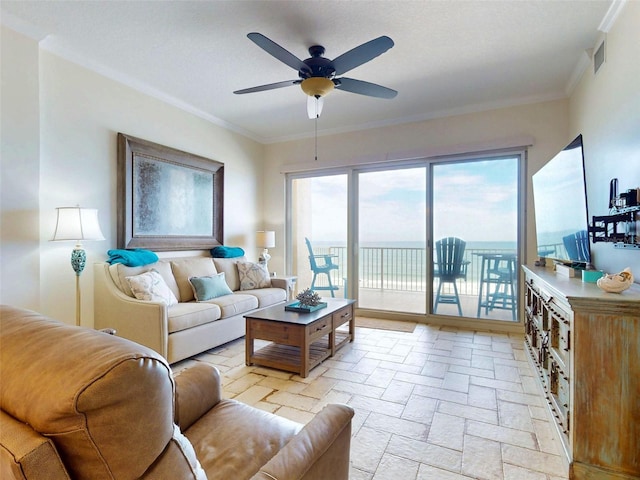 living area with ornamental molding, visible vents, and a ceiling fan