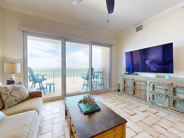 living area featuring plenty of natural light, visible vents, and ornamental molding