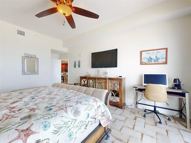 bedroom featuring visible vents, ceiling fan, and stone tile floors