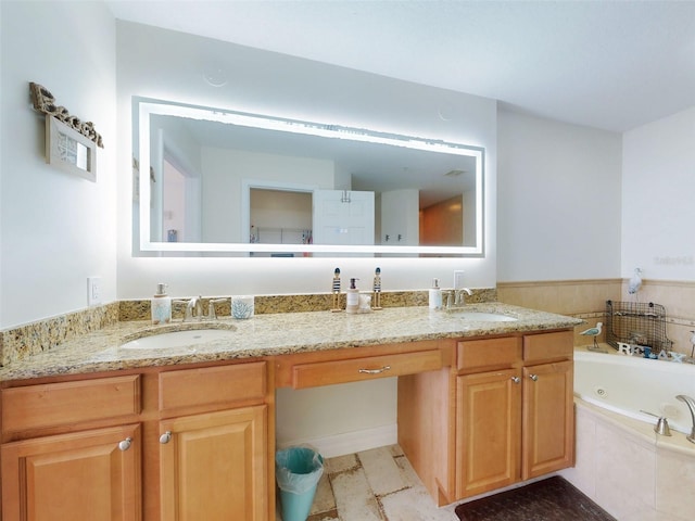 bathroom featuring a whirlpool tub, double vanity, and a sink