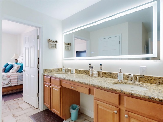 ensuite bathroom featuring ensuite bathroom, double vanity, and a sink