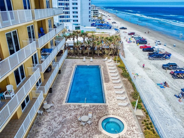 view of pool with a water view and a view of the beach