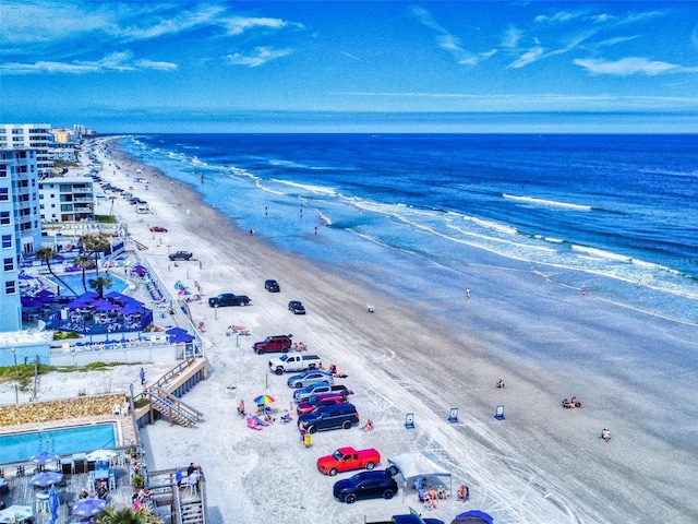 bird's eye view featuring a water view and a beach view