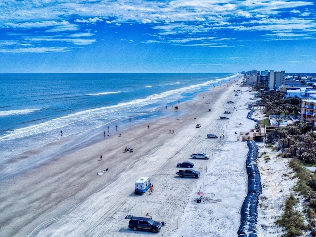 drone / aerial view with a water view and a view of the beach